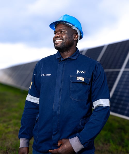 working man standign near solar panel