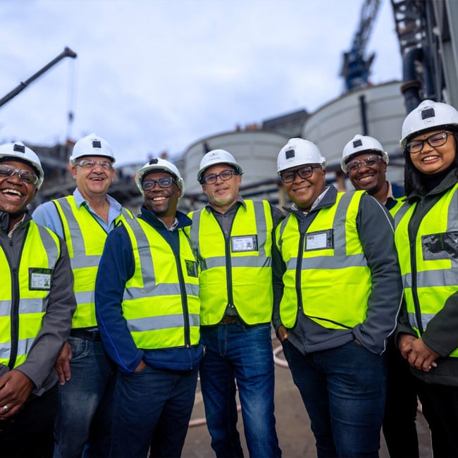 smiling team in visor vests
